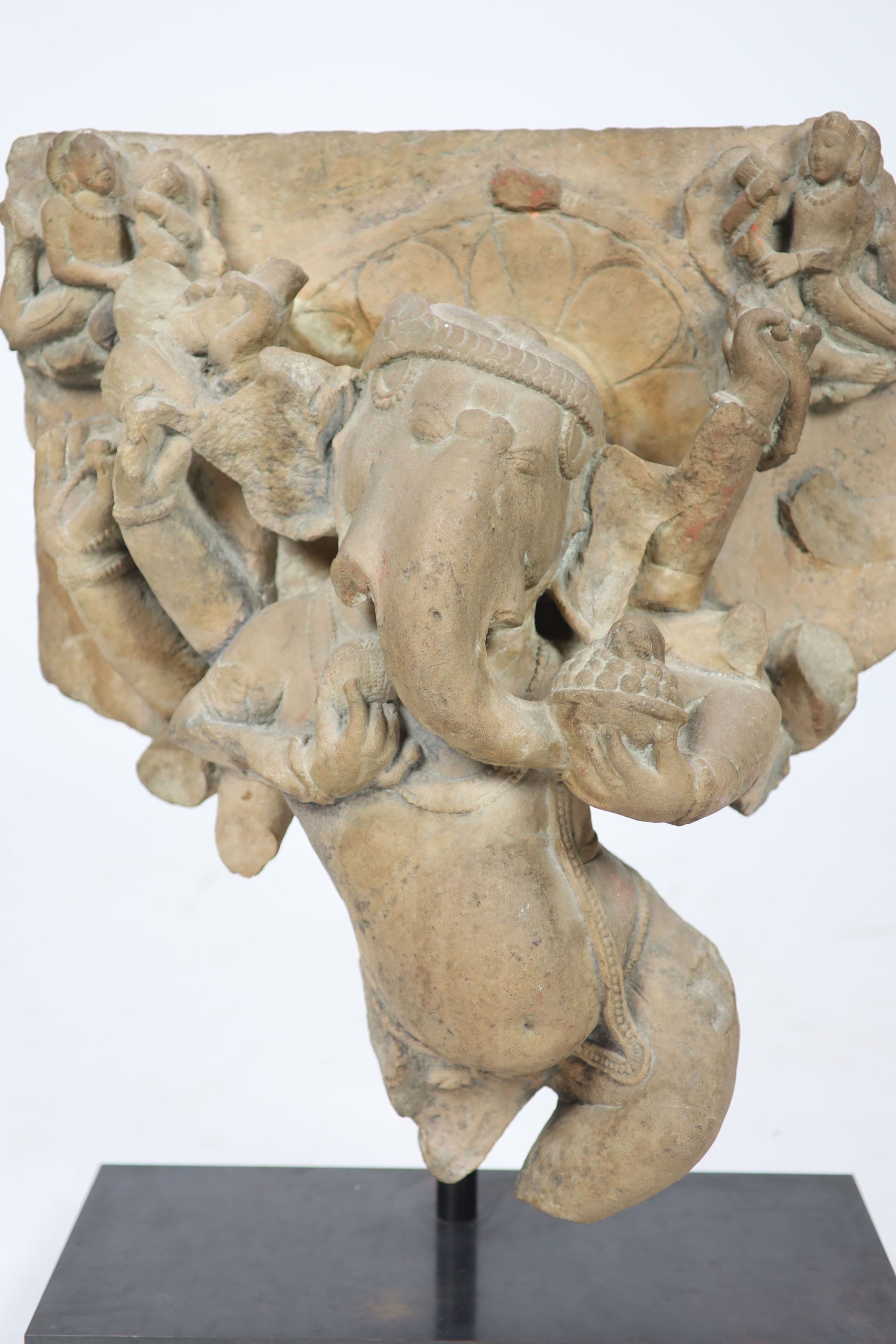 An Indian sandstone Ganesha stele fragment, Rajasthan 11th/12th century, 66cm high, 60 cm wide, excluding metal stand